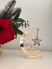 Golden acrylic 'Ramadan Kareem' crescent moon and star decorative stand for home decor or Ramadan gift.